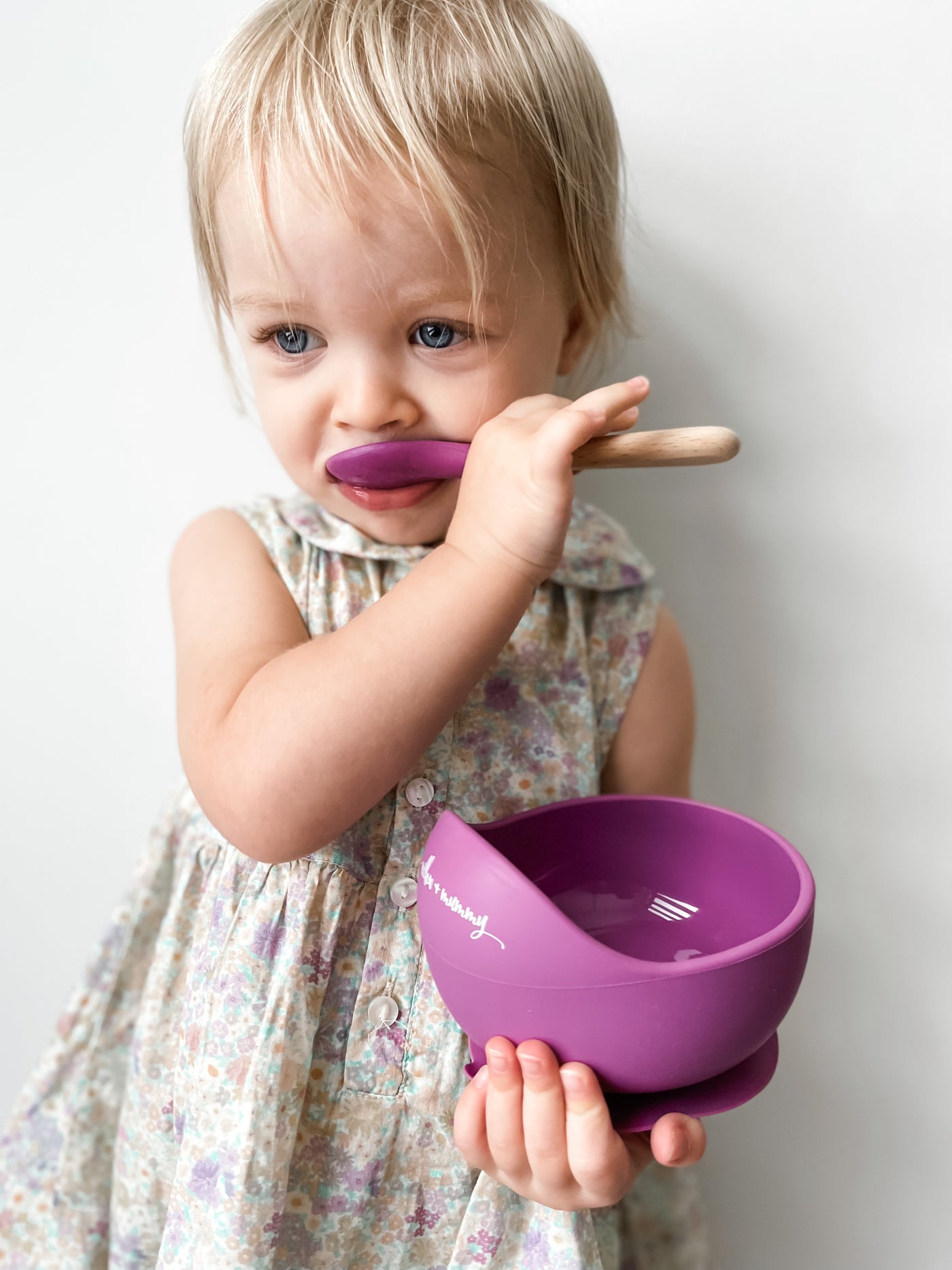 Toddler holding our Plum Silicone Bowl
